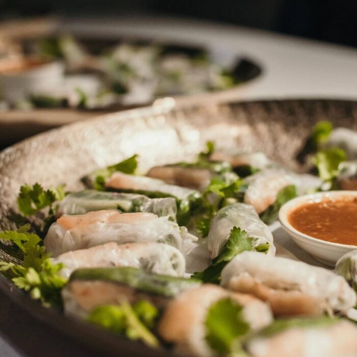 A delicious plate of spring rolls and sweet chilli sauce, catered by Goodie Group